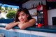 A woman leaning on a counter in a restaurant.