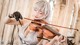 A woman in a white dress playing a violin.