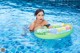 A woman in a swimming pool with an inflatable ring.