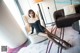 A woman sitting on a chair in a living room.