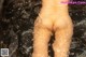 A naked woman is taking a bath in the water.