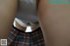 A close up of a person wearing a plaid skirt.